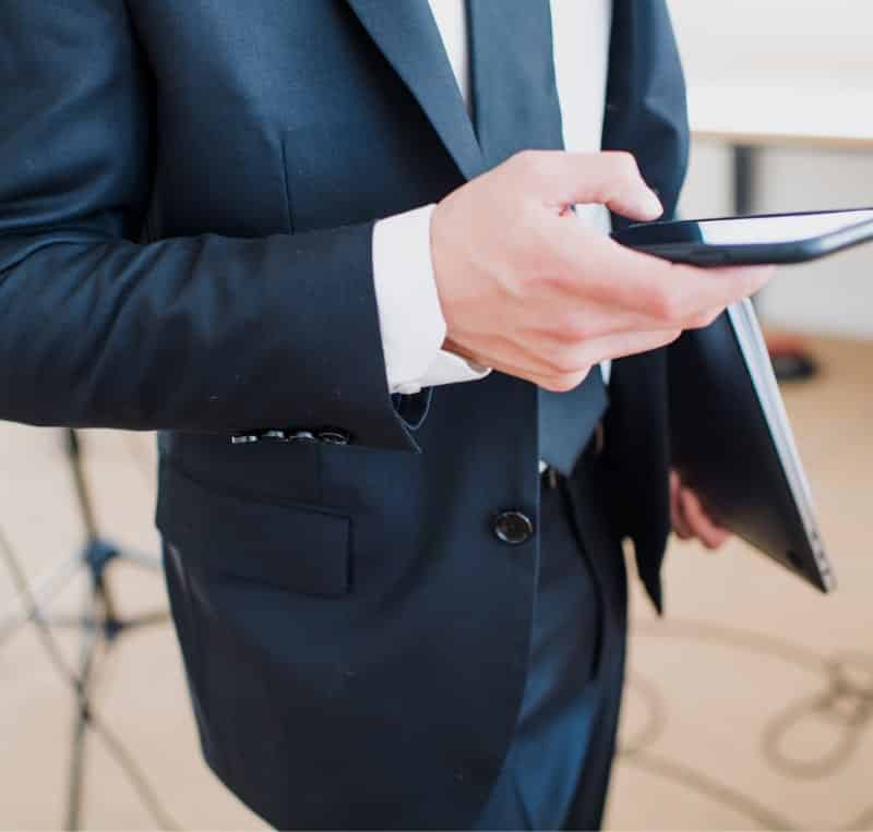 man in suit using his phone